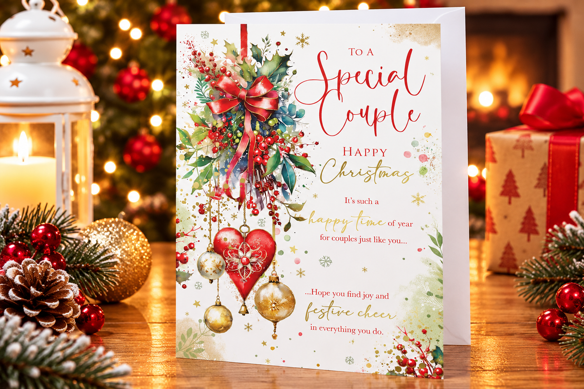 Special Couple Christmas card on festive table beside lantern and Christmas decorations