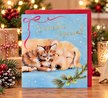 Someone Special Christmas card with kitten and puppy displayed with red envelope and festive Christmas decorations