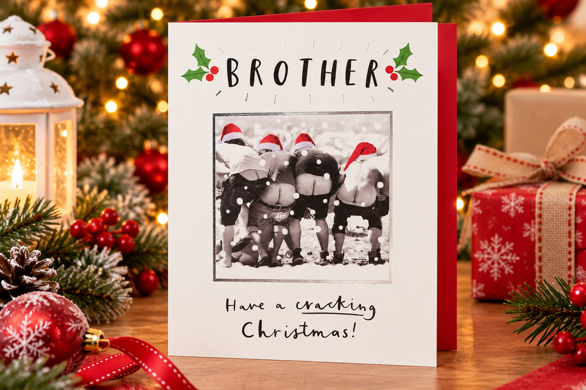 Funny Brother Christmas card by Paperlink displayed beside Christmas decorations and lantern