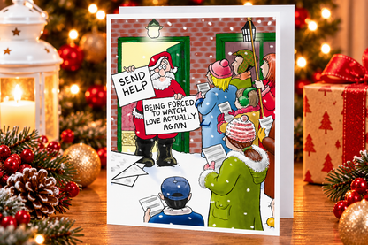 Paperlink funny Santa Christmas card on festive table with lights and gifts