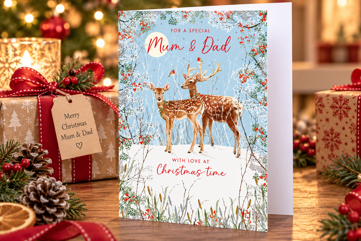 Nigel Quiney Mum and Dad Christmas card styled beside festive presents and candle
