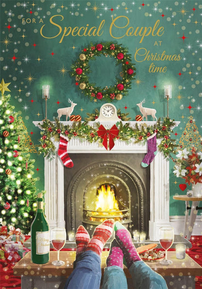 Special Couple Christmas card front with festive fireplace, wreath and gold lettering by Nigel Quiney