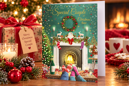 Special Couple Christmas greeting card displayed on festive table with gifts and candle
