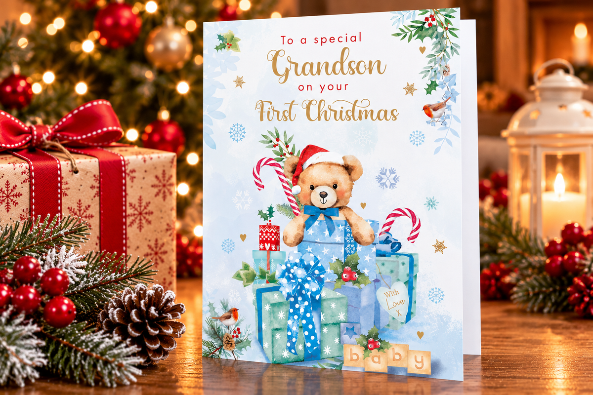 Nigel Quiney Grandson First Christmas teddy bear greeting card displayed in a festive Christmas setting