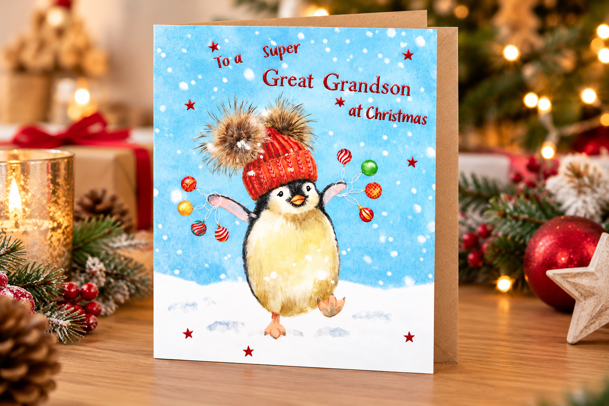 Otter House Great Grandson penguin Christmas card in festive lifestyle setting with candle, decorations and gift