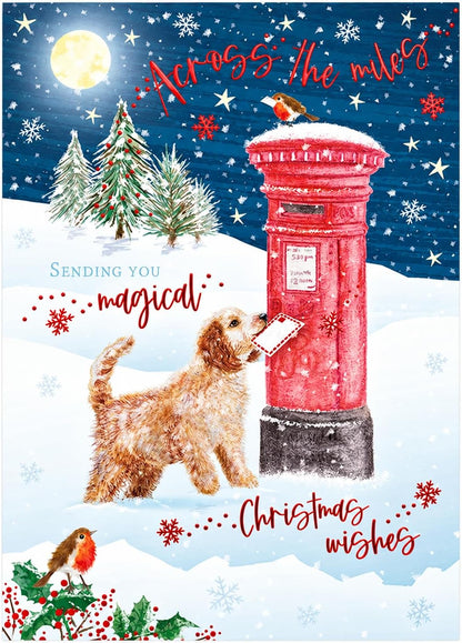 Otter House Across the Miles Christmas card front with dog posting a letter at red postbox in snowy winter scene with robins