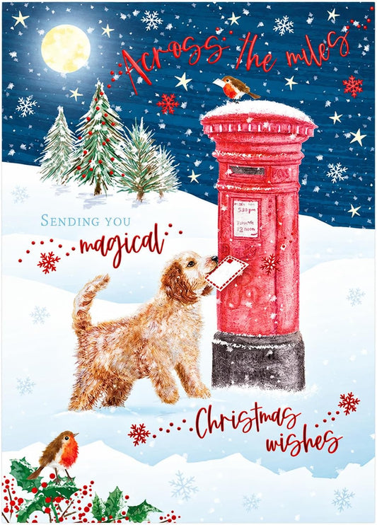Otter House Across the Miles Christmas card front with dog posting a letter at red postbox in snowy winter scene with robins