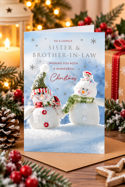 Snowmen Christmas card for sister and brother-in-law displayed in festive setting