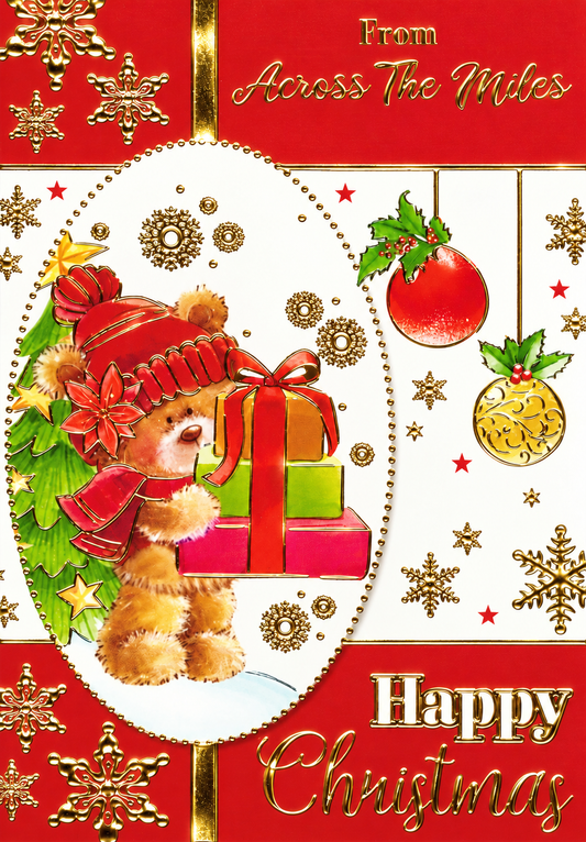 Front of Across the Miles Christmas card showing teddy bear with presents and gold foil snowflakes