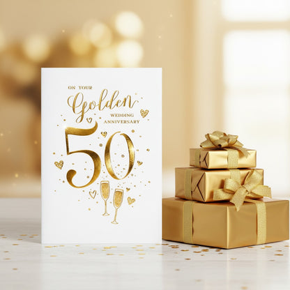 Made To Be Treasured 50th golden wedding anniversary card with gold foil text, hearts, and champagne glasses.