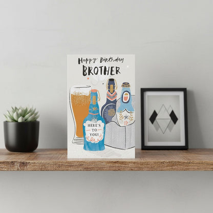 Made To Be Treasured Happy Birthday Brother card with beer bottles and a pint glass, featuring gold foil accents.