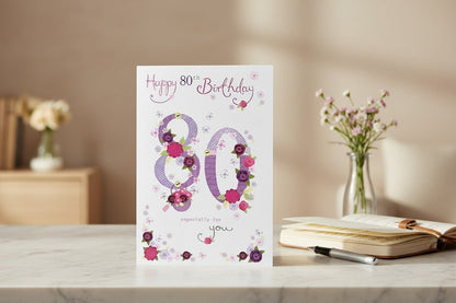 Made To Be Treasured Nigel Quiney 80th birthday card with pink and purple floral number design and glitter finish