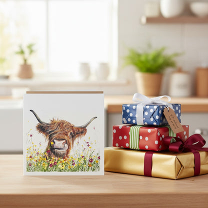 Made To Be Treasured Tracks Publishing blank greeting card featuring a Highland cow illustration among colourful wildflowers