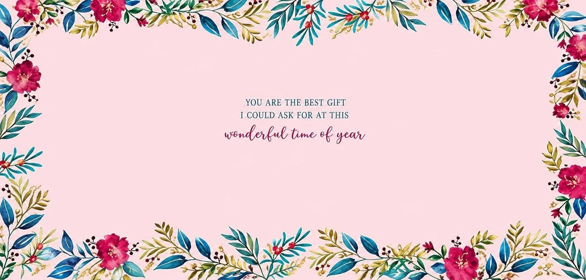 Inside of Otter House Wife Christmas card with pink background, floral border and loving message