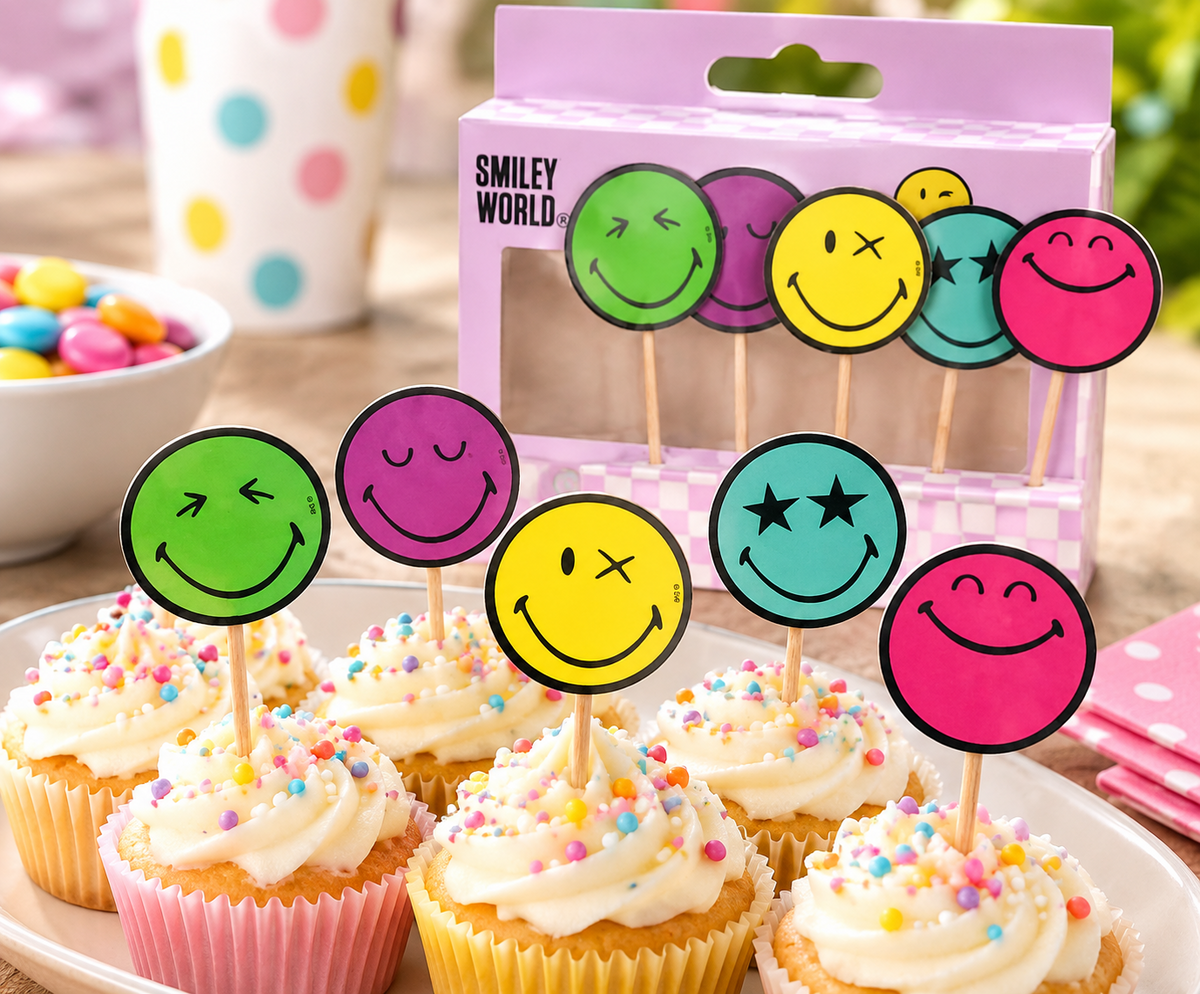 Five colourful Smiley World smiley face cake toppers decorating cupcakes at a birthday party